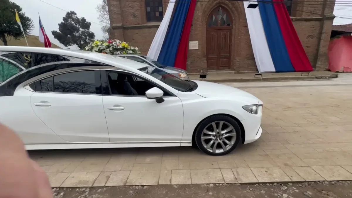 Carroza fúnebre frente a una iglesia