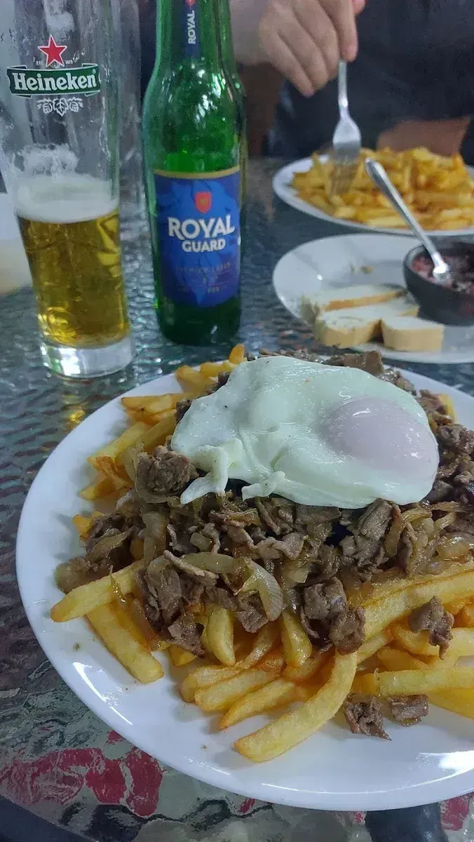 Chorrillana de Casa Café Teno con huevo frito, carne y papas fritas en la terraza
