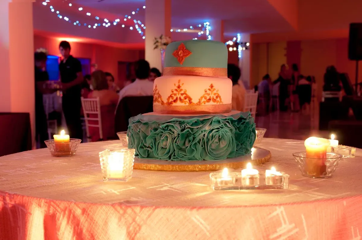 Torta de matrimonio con chispas mientras la fiesta sigue atrás
