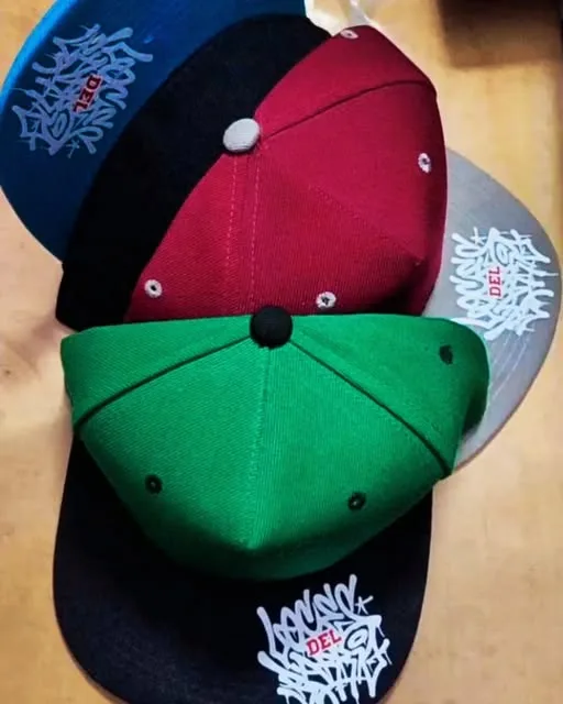 Gorras estampadas de varios colores sobre la mesa de trabajo