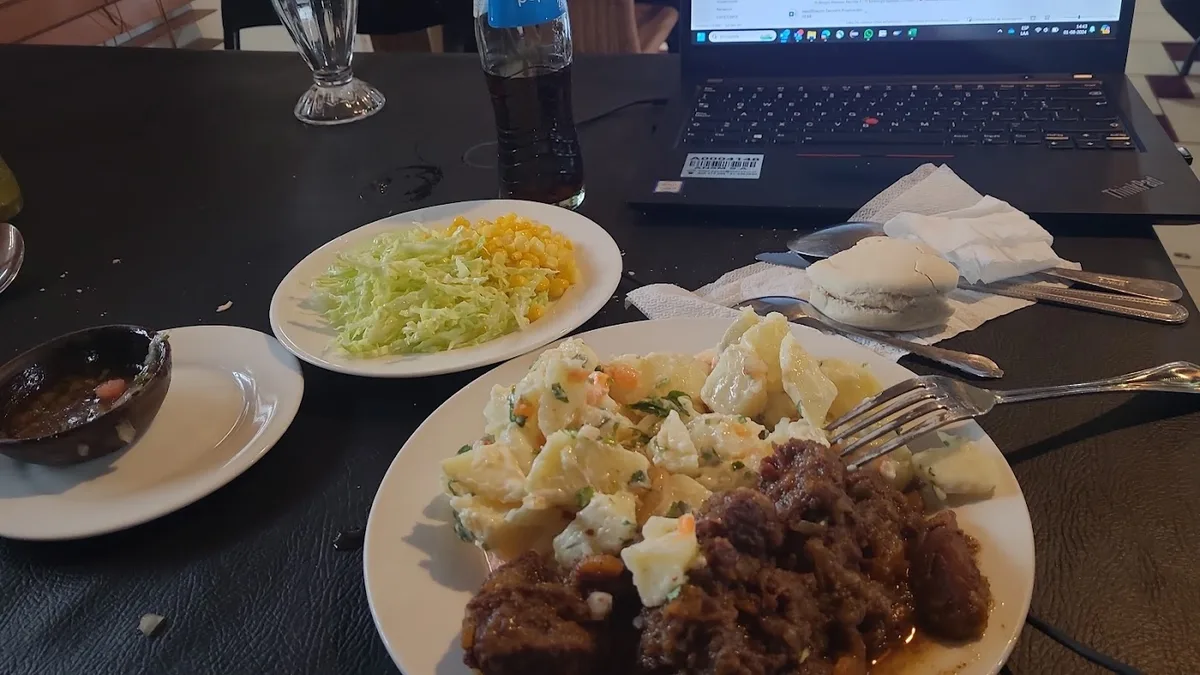 Plato de almuerzo casero con carne, arroz y ensalada en La Tribu Silva