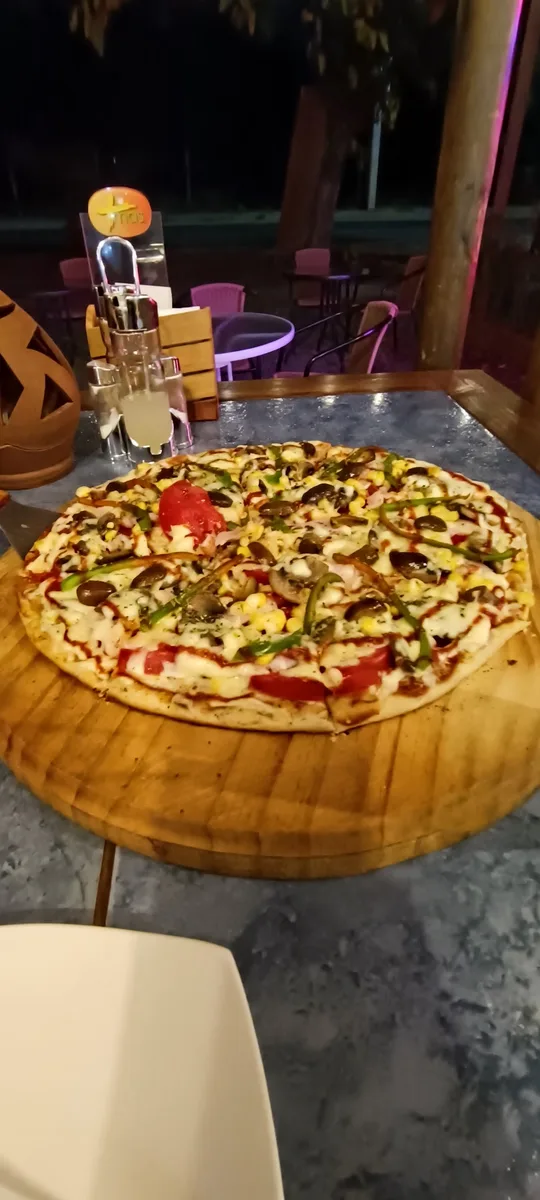 Pizza en tabla de madera en La Tribu Silva, Maule