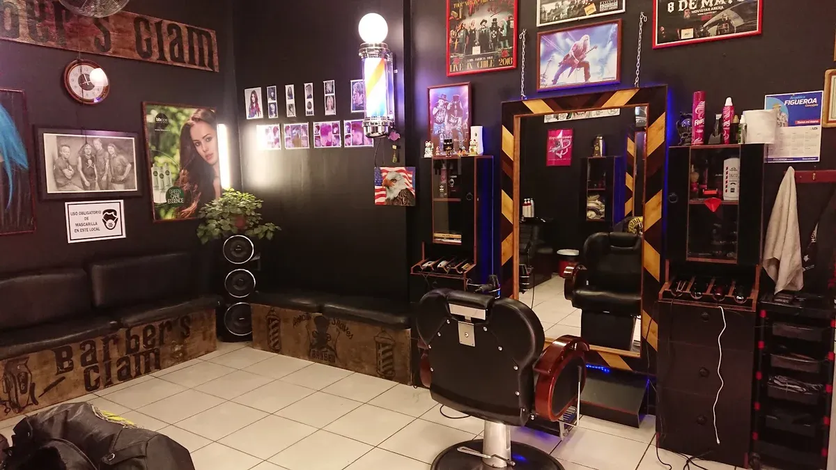 Interior de Barber's Glam con afiches de rock en la pared