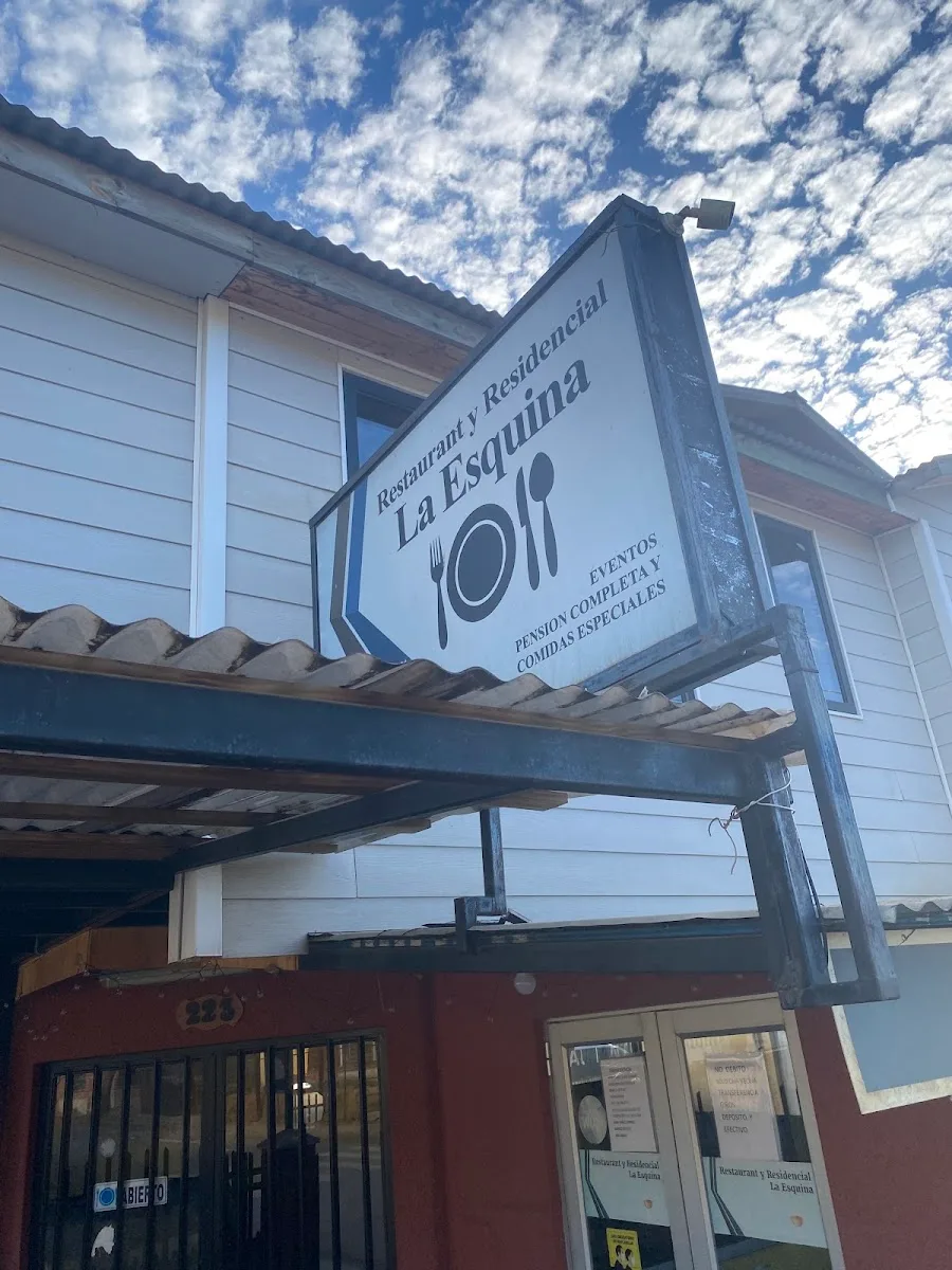 Letrero colgante de La Esquina con su logo circular de plato y cubiertos