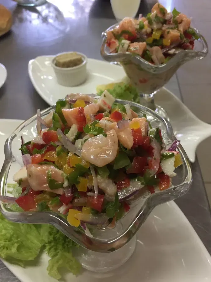 Copas de cóctel de camarones y pescado con verduras frescas picadas
