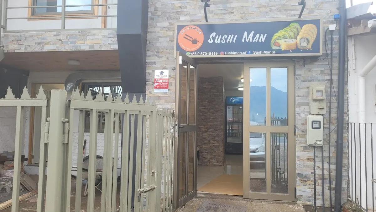 Fachada real de Sushiman en Villa Esperanza: letrero circular rojo y negro con el logo