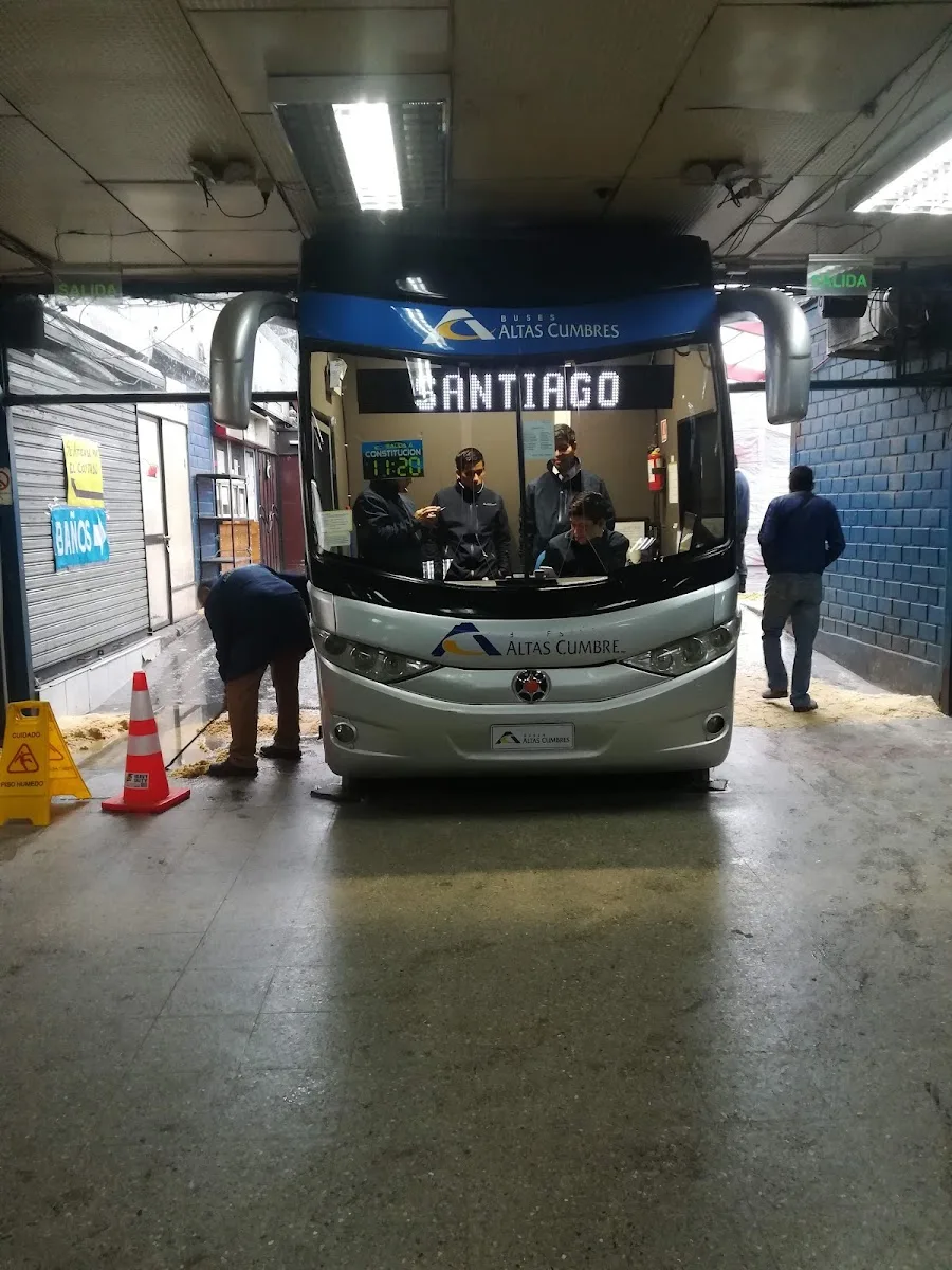 Pasajeros embarcando en un bus con destino Santiago en el andén del terminal